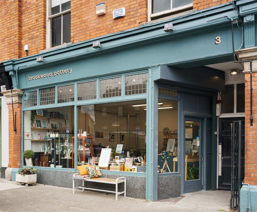 The green shopfront exterior of Brookwood Pottery