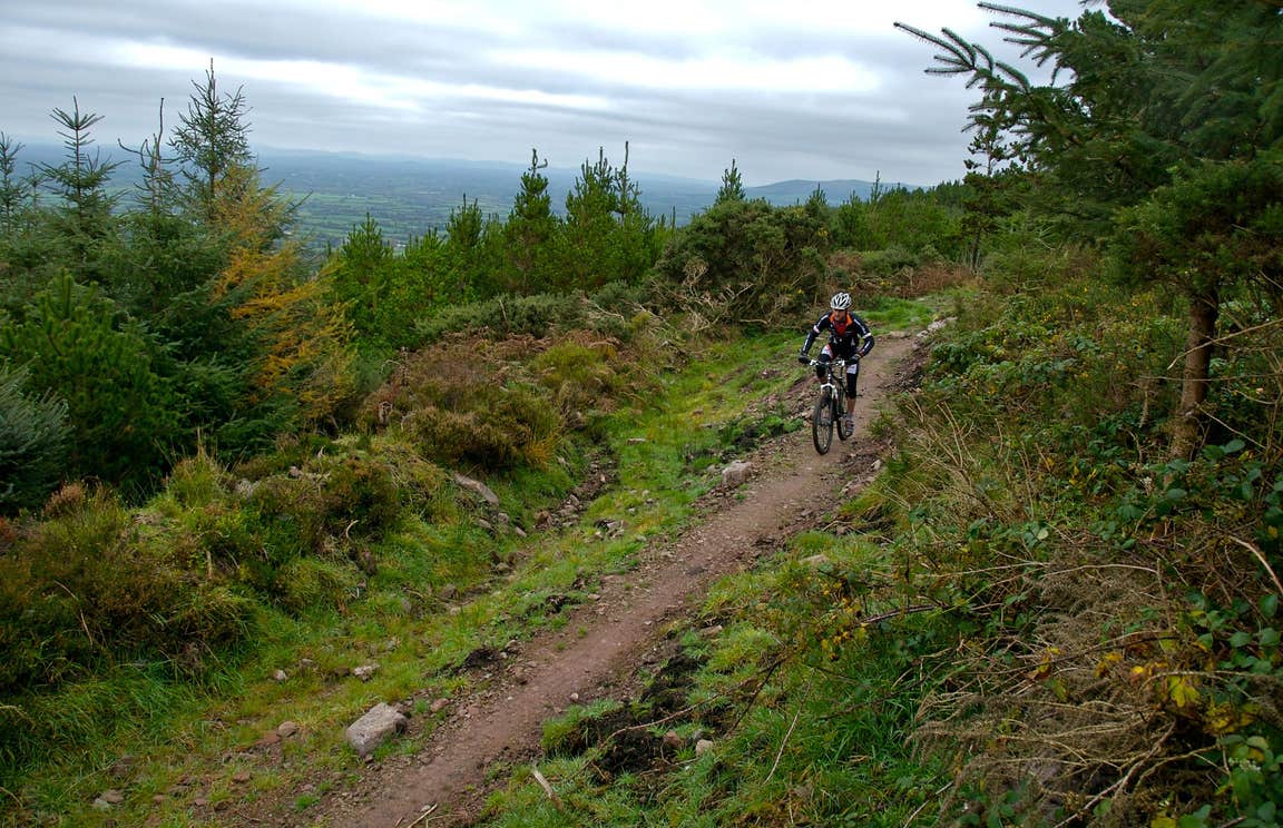 A man wearing a helmet and cycling gear navigating one of the Ballyhoura Mountain Bike Trails