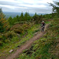 A man wearing a helmet and cycling gear navigating one of the Ballyhoura Mountain Bike Trails