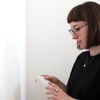 Kim Crowley looking at a book she's holding