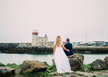 A wedding couple looking at the lighthouse
