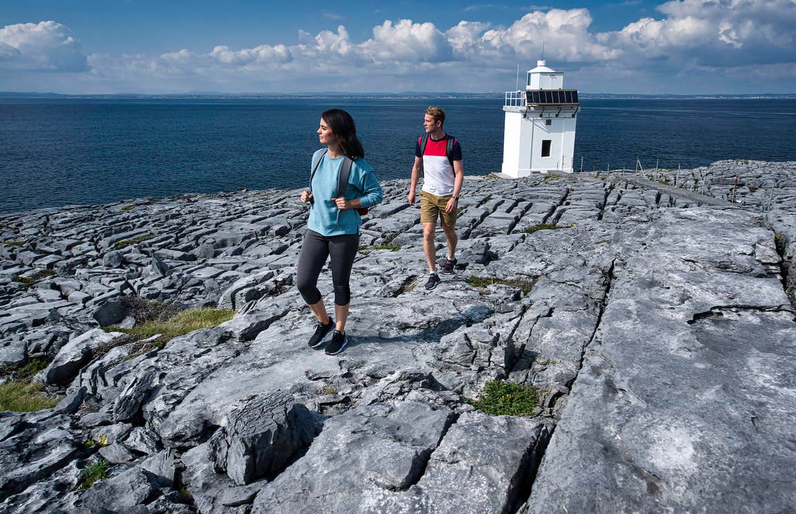 People walking along Black Head Lighthouse in the Burren, Co Clare
