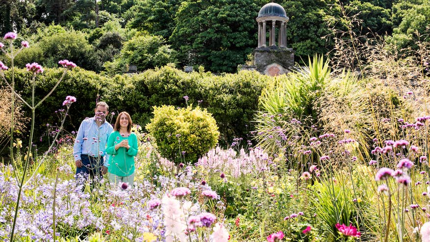 A couple walking through the gardens at Bantry House in West Cork