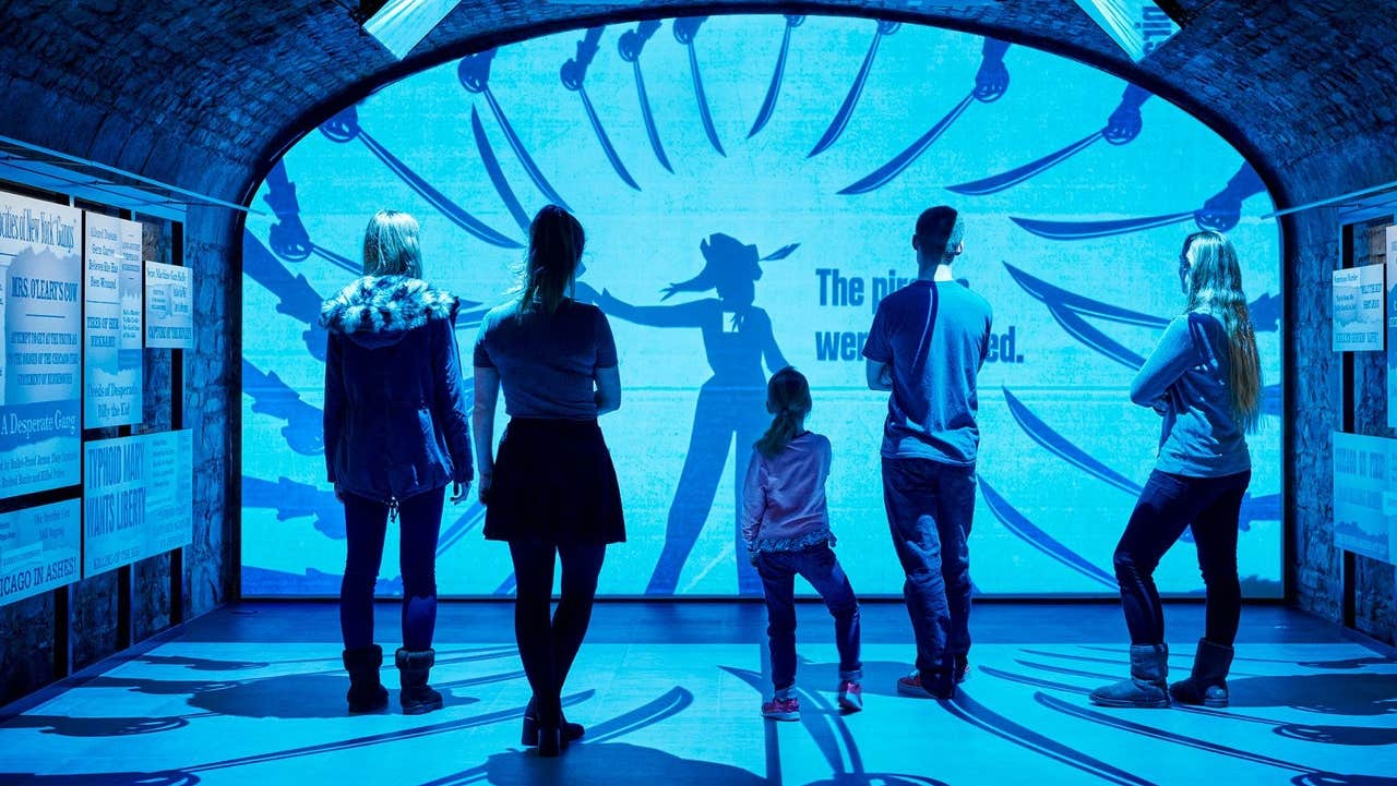 A group of people watching a visual display