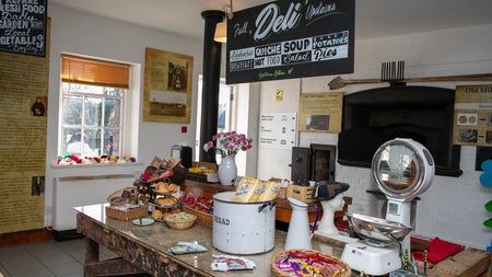 A café counter with lots of items displayed on it