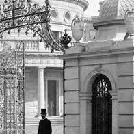 Cut & Paste No. 9 2026: Remembering Arthur Griffith, old black and white photo of gentleman walking through ornate iron gates from a Georgian building.