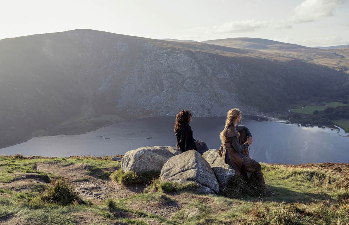A scene from the tv series 'Vikings' showing two women looking down at Glendalough in county Wicklow.