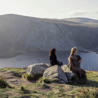 A scene from the tv series 'Vikings' showing two women looking down at Glendalough in county Wicklow.