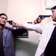 Two men pointing pistols at each other.