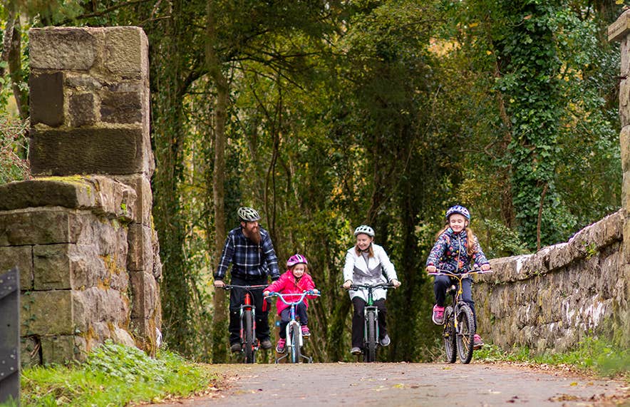 A family cycling on the Killykeen Way Greenway in Co Cavan