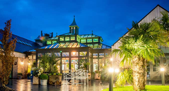 The exterior of The Shed Distillery lit up at night