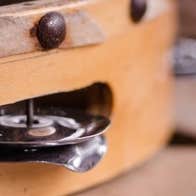 Close up view of the side of a tambourine.
