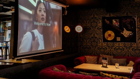 Comfortable seating area in a bar with a table and a menu on display