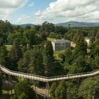 An aerial view of the treetop walkway with Avondale House in the background