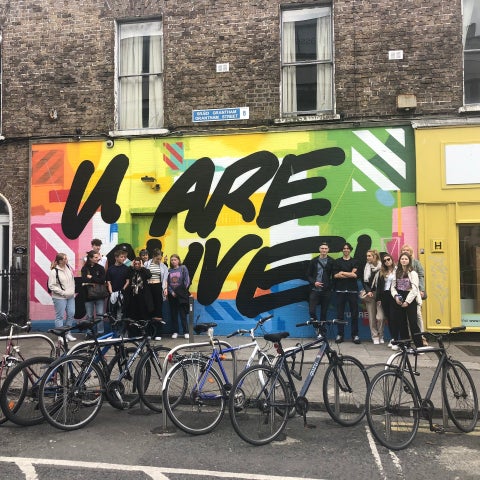 A tour group enjoying a street art tour of Dublin City with Artful Tours