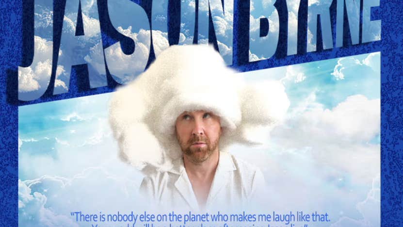 A man looking upwards in white shirt with head covered in huge, white, fluffy hat surrounded by clouds