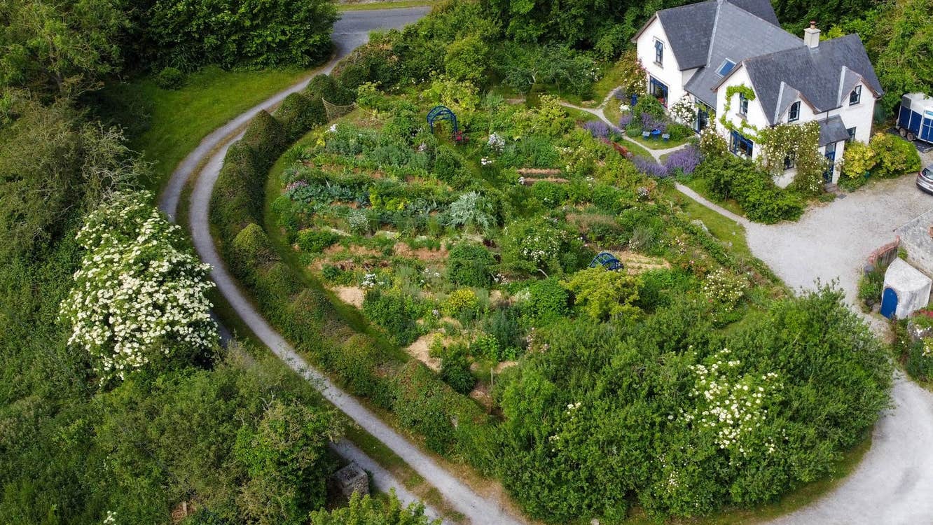An aerial view of a house with a substantial garden