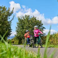 People cycling the Waterford Greenway