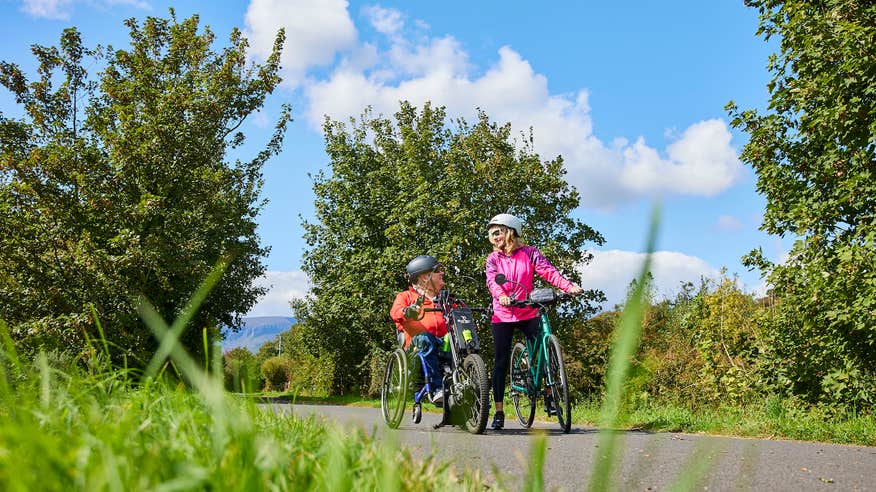 People cycling the Waterford Greenway