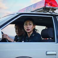 Two scared police officers in a police car.