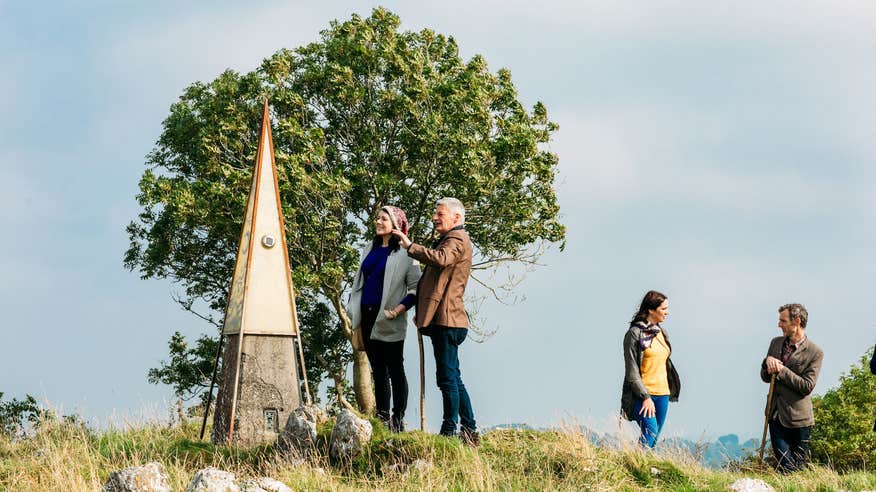 Four people on top of Hill of Uisneach in County Westmeath.