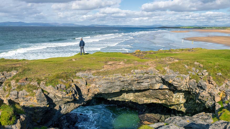 A man standing on the Fairy Bridges in Bundoran, County Donegal