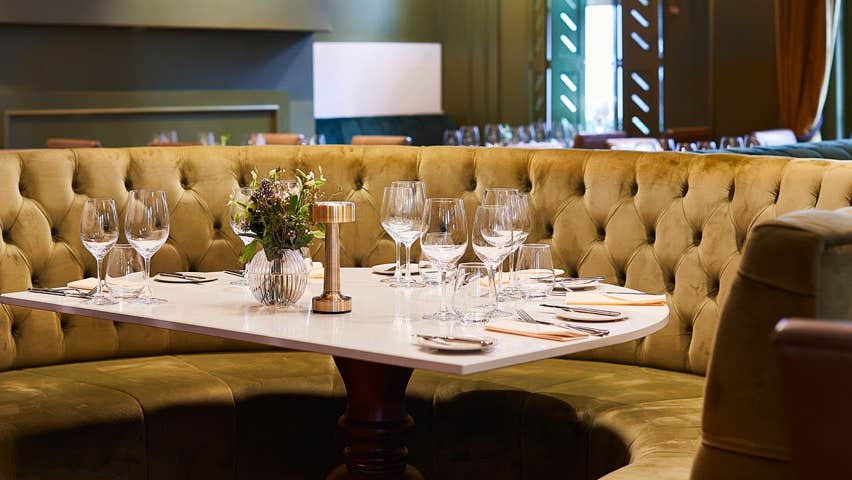 A round seating area with a table laid out for customers