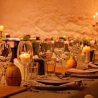 Firelit courtyard with medieval-inspired cocktails, setting the mood for a vibrant, interactive long-table feast.