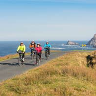 Family cycling along the coast in Donegal