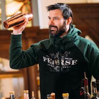 Dublin by Dusk: The Cocktail Experience, a smiling man in logo sweatshirt is holding up a cocktail shaker