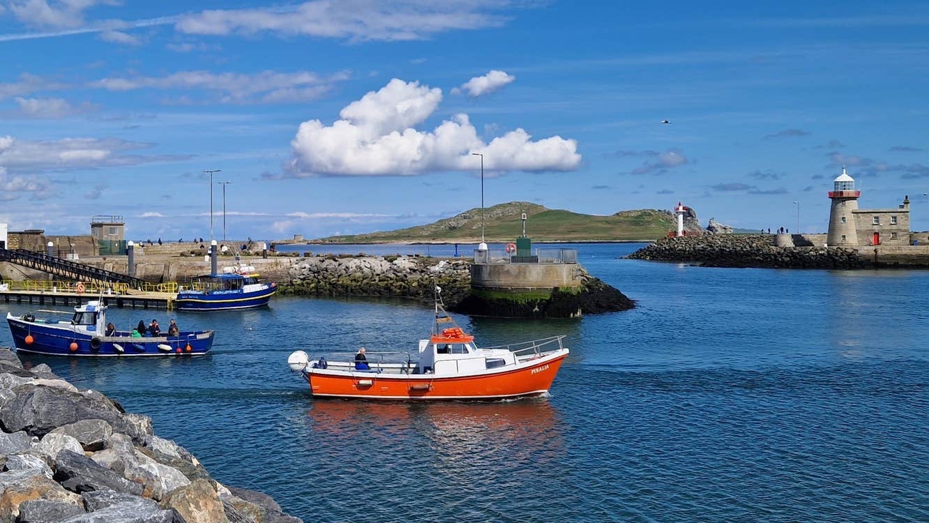 A small ferry boat departing a harbour