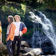 People standing by the waterfall on the Glenbarrow Eco Walk, Co Laois