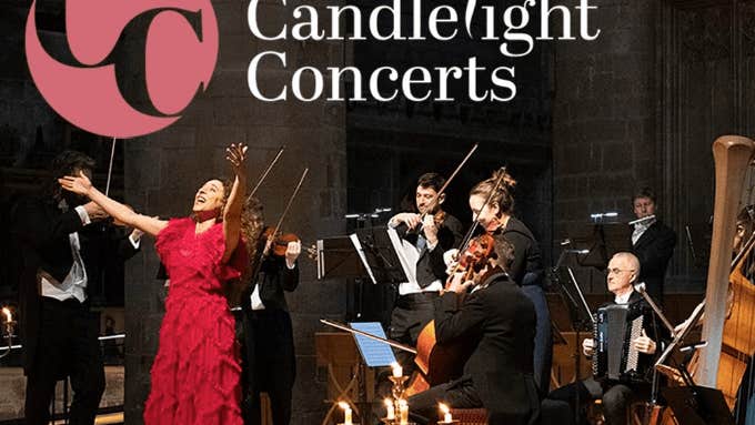A woman in red dress with outstretched arms is singing with small group of musicians behind her
