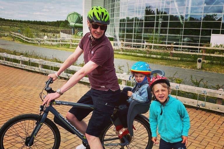Dad and two kids off on a cycle in Centre Parcs, Longford