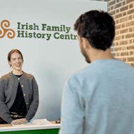 A visitor arrives for a genealogy consultation at the Irish Family History Centre, located at EPIC The Irish Emigration Museum in Dublin's Docklands. Expert guidance helps visitors explore their Irish ancestry.