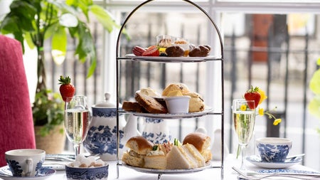 An afternoon tea setting with glasses of prosecco