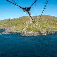 Cables above the sea with mainland in the background