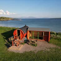 Sona Sauna at Ventry Beach with Ventry village and the sea in the background