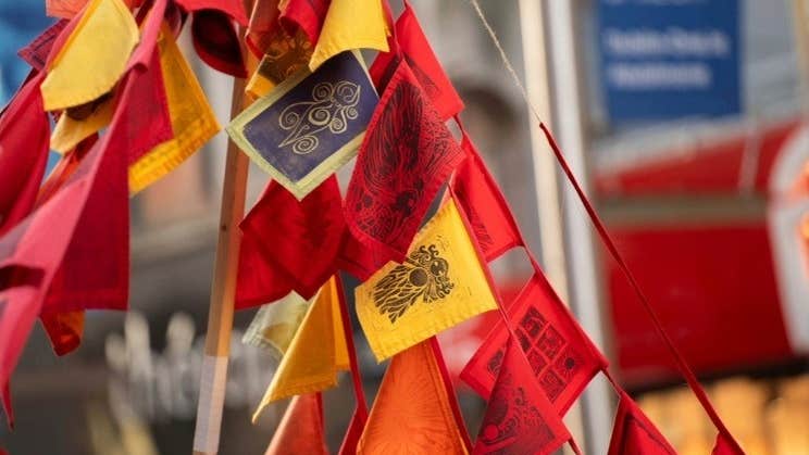 Brigid's Day Imbolg Celebration at Butler Gallery - a bunch of small flags in red, orange and yellow