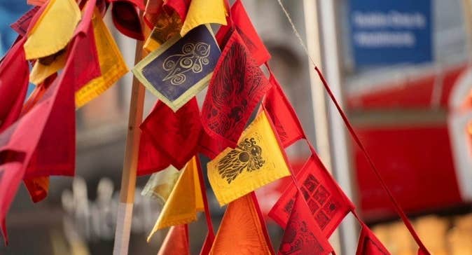 Brigid's Day Imbolg Celebration at Butler Gallery - a bunch of small flags in red, orange and yellow