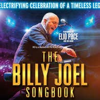 An lively man singing and playing a piano