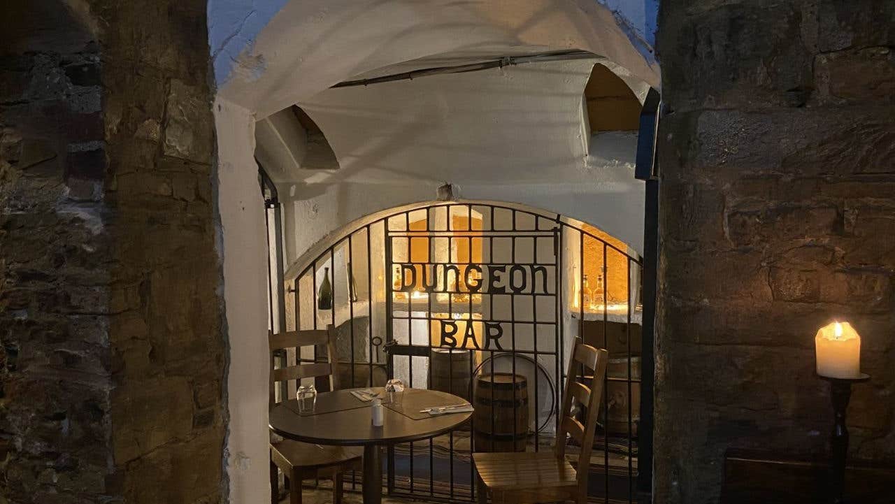 Dimly lit bar with a gated entrance
