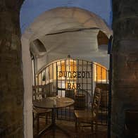 Dimly lit bar with a gated entrance