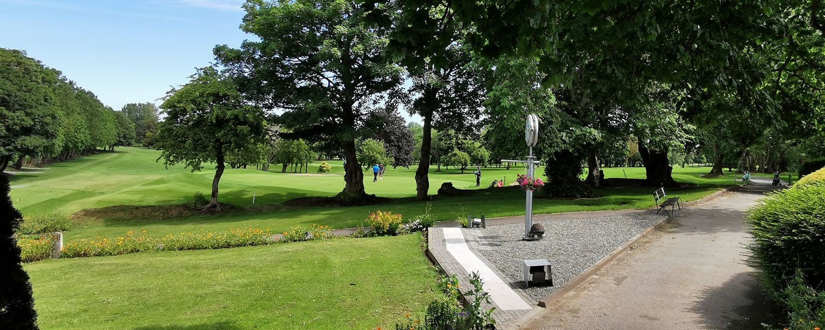 A view of the 18th green and the 1st tee box with fairways in the background