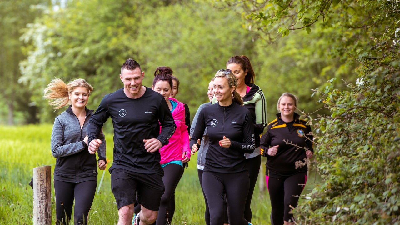 A group running in nature during a retreat