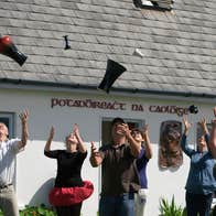 People throwing pottery in the air outside Louis Mulcahy Pottery