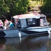 Passengers on a small boat enjoying a tour on a lake