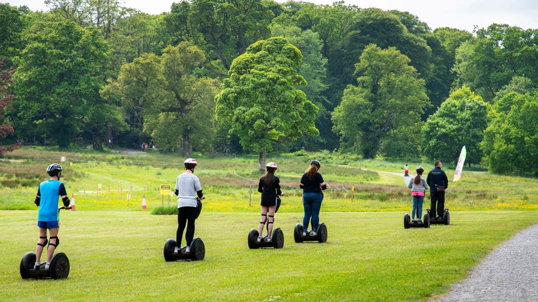 Six people riding a Segway on grass in Lough Key, Roscommon