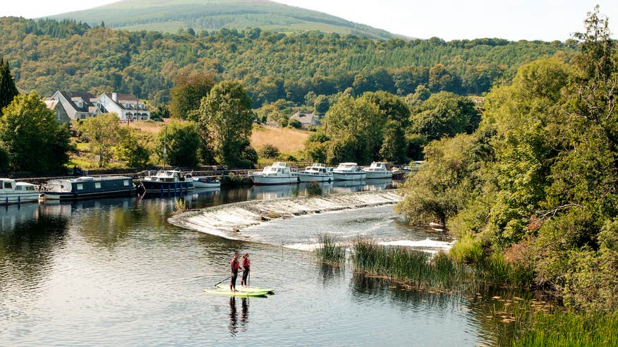 People stand-up paddleboarding in the River Barrow in Graiguenamanagh, Co Kilkenny