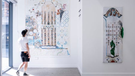 A man looking at the Shahid Diaa mixed media exhibition on display at The LAB Gallery